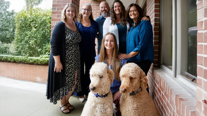 Chiropractor Amherst NH Jenny Bruck With Team and Dogs About