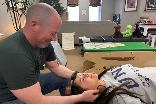 Chiropractic Amherst NH Doctor Helping Patient With Neck Pain